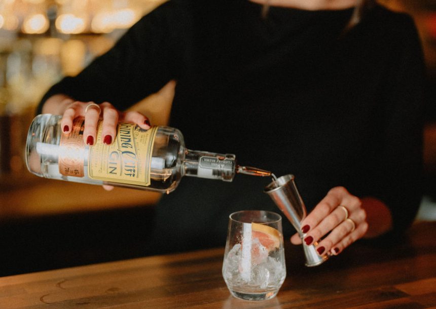 Woman making gin cocktail